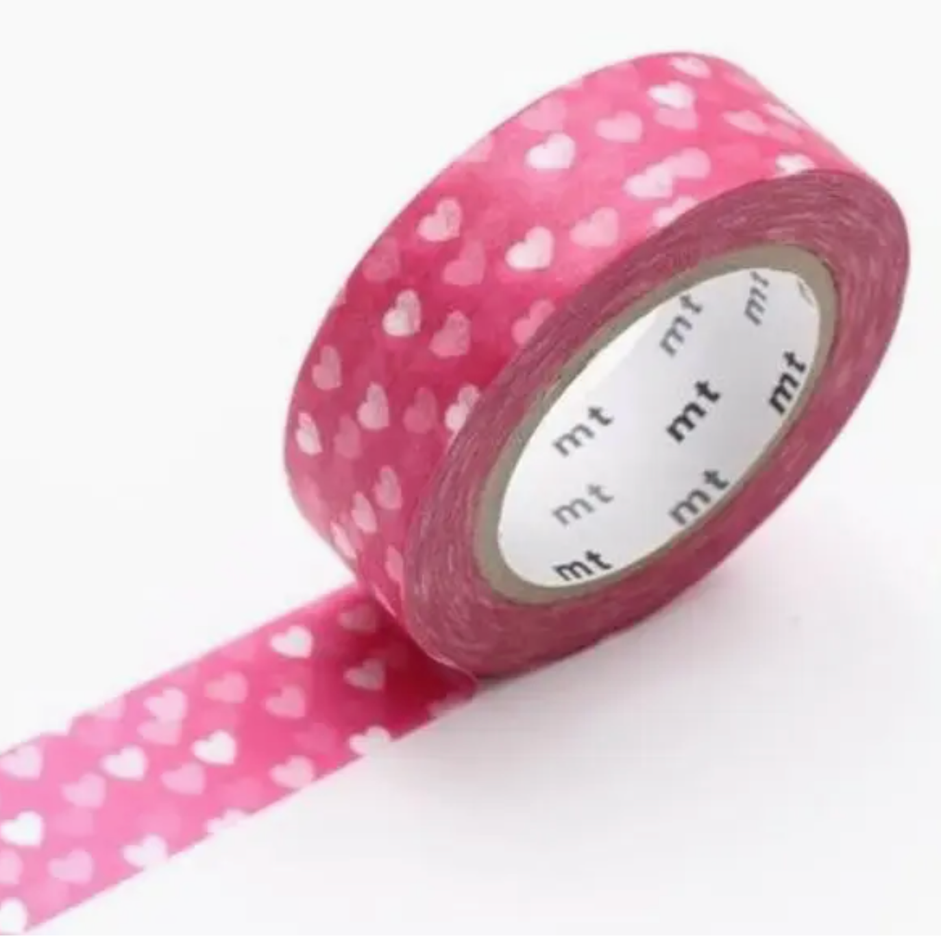 Roll of pink tape with white heart pattern on a white background