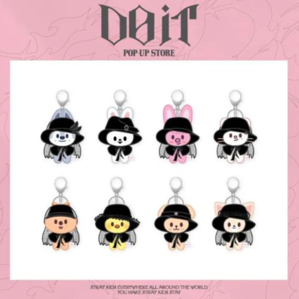 Set of cartoon character keychains with black hats on a pink background, featuring the brand 'DOIT'.