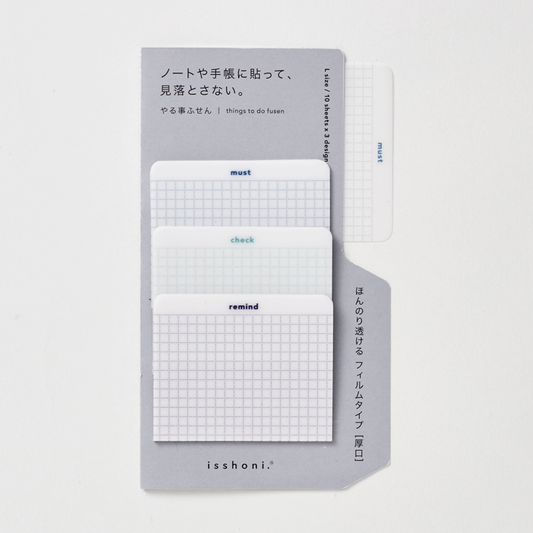 Set of three small notebooks with grid patterns and text on a light gray background
