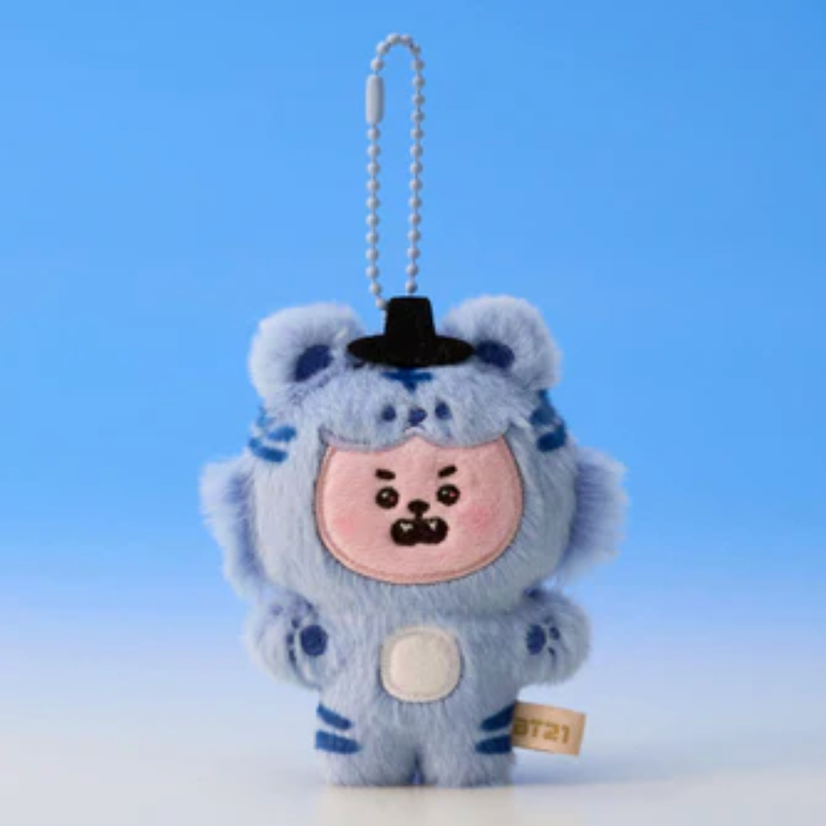 Plush keychain of a character in a blue outfit with a black hat on a light blue background