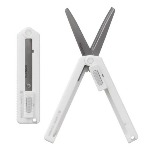 White folding scissors with a black blade on a white background