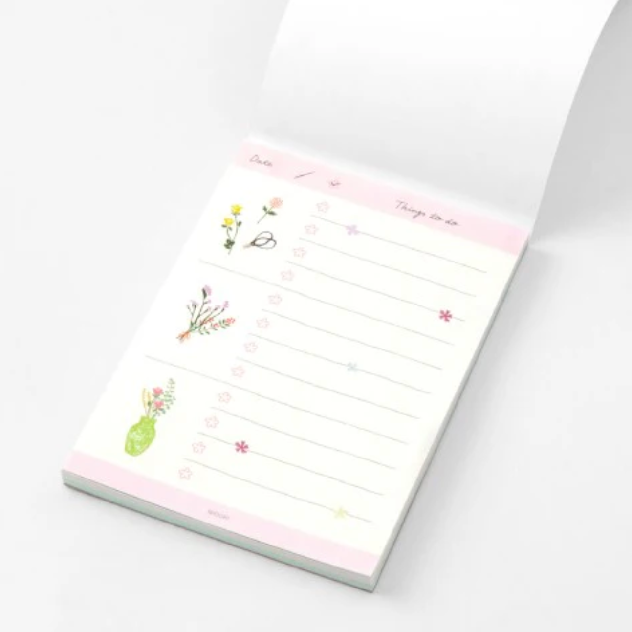 Notepad with floral designs on a white background
