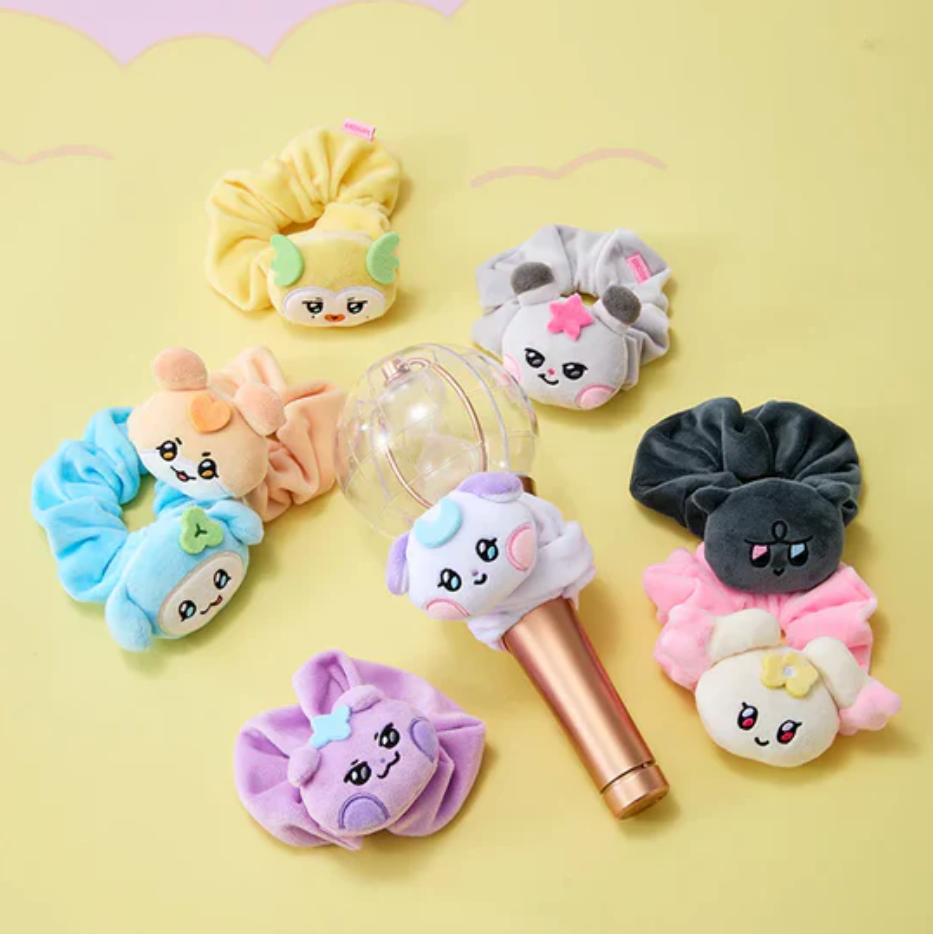 Set of colorful hair accessories with cartoon faces on a yellow background