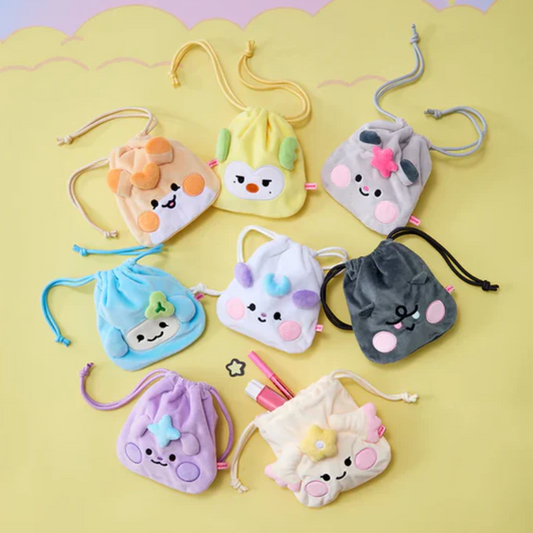 Set of small, colorful pouches with cartoon faces on a yellow background