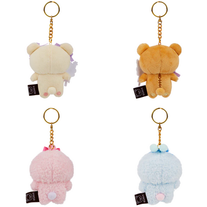 Four plush keychains in different colors on a white background