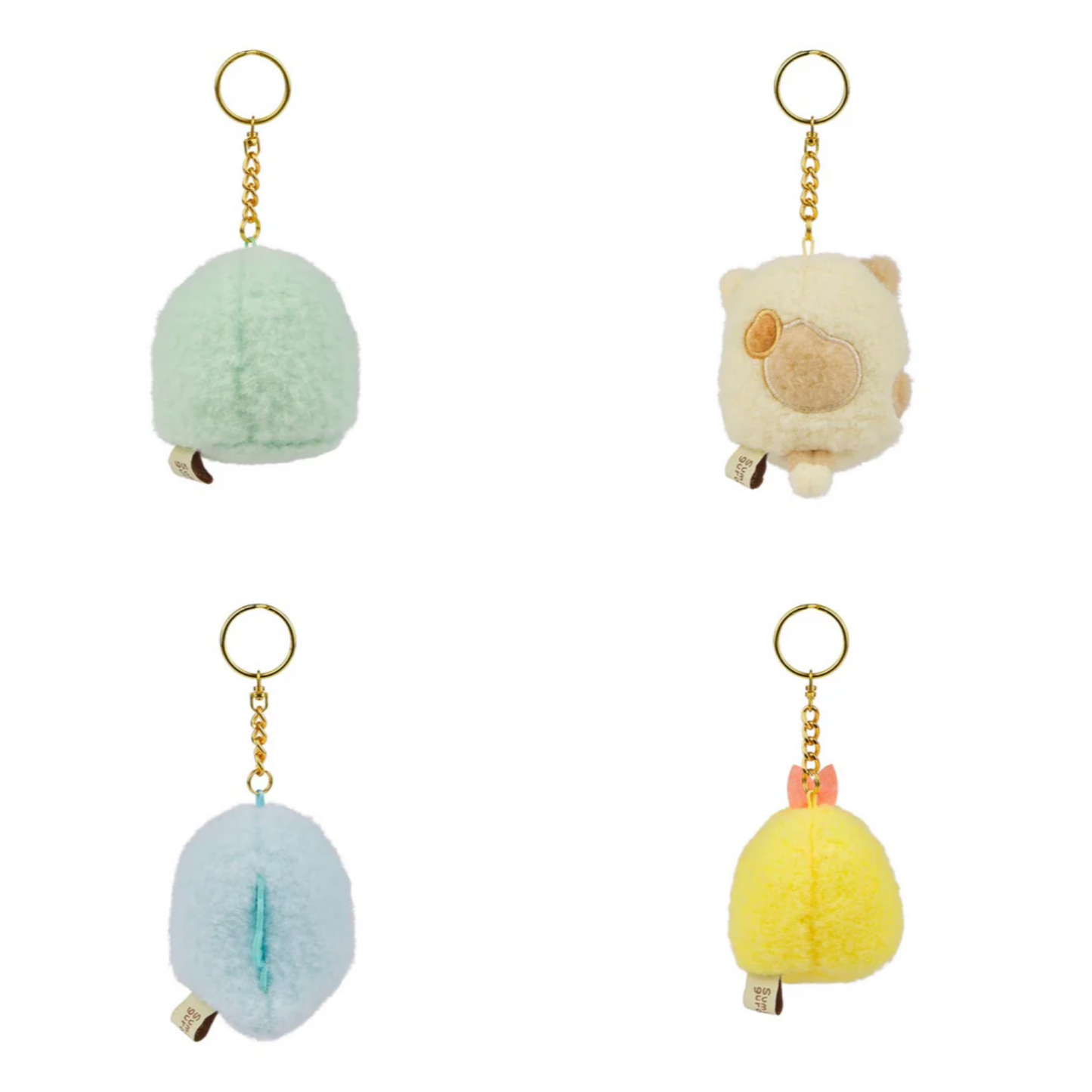 Four plush keychains in different colors on a white background
