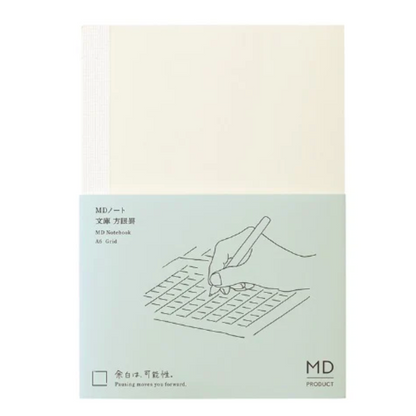 Notebook cover with a hand holding a pen over a grid design on a light green background.