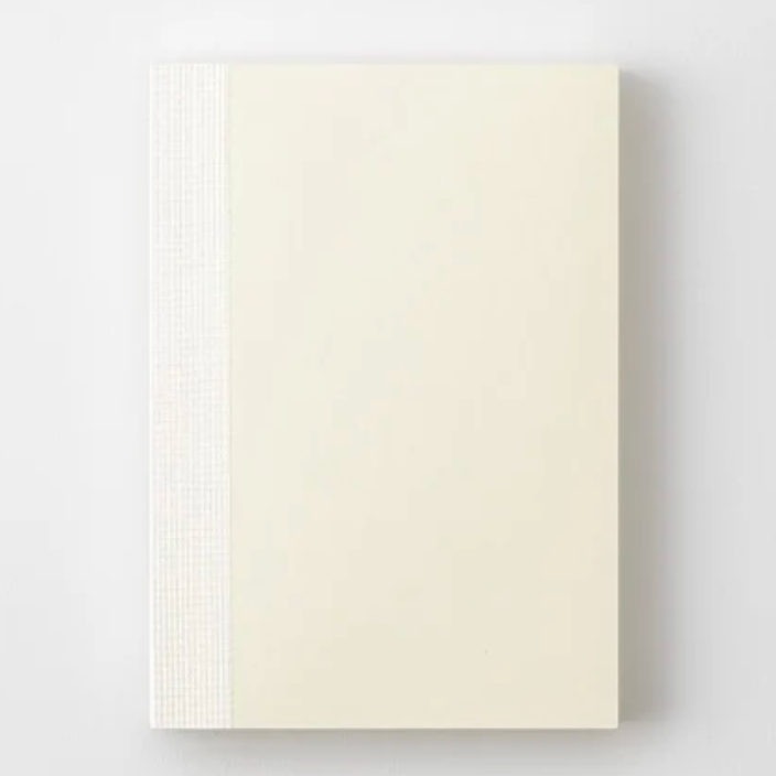Beige color notebook on a light gray background