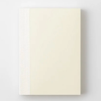 Beige color notebook on a light gray background