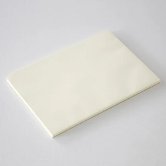 Rectangular white paper pad on a light gray background