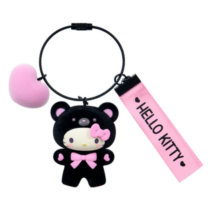 Keychain with a black bear character wearing a pink bow and 'Hello Kitty' tag on a white background