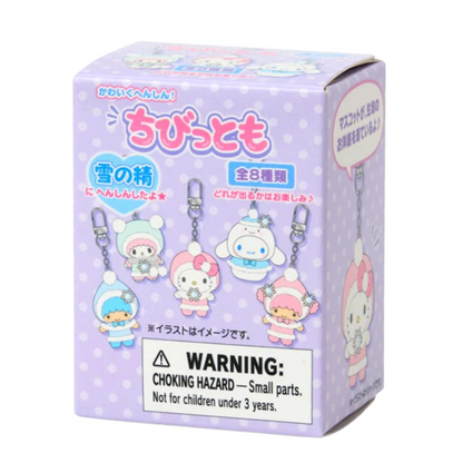 Box of small character figurines keychain with a warning label on a white background