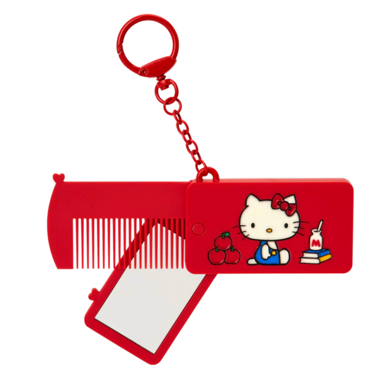 Red comb and mirror set with a cartoon character keychain on a white background