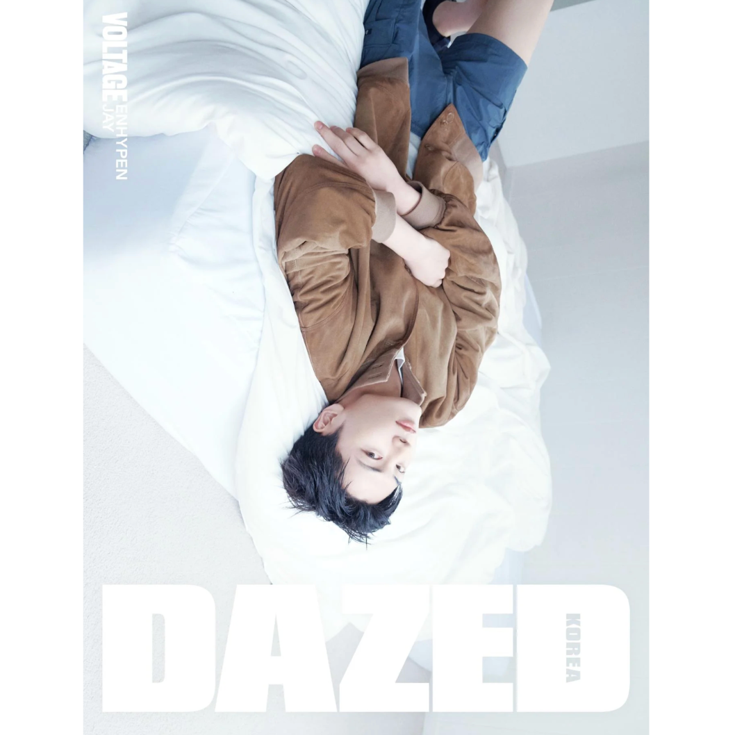 Person lying on a bed with a magazine cover featuring the brand 'Dazed' in the background.