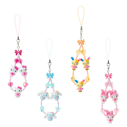 Set of four colorful phone charms with cartoon characters on a white background