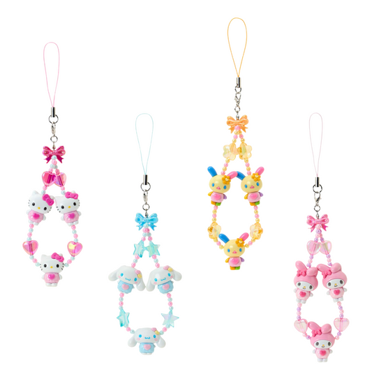 Set of four colorful phone charms with cartoon characters on a white background
