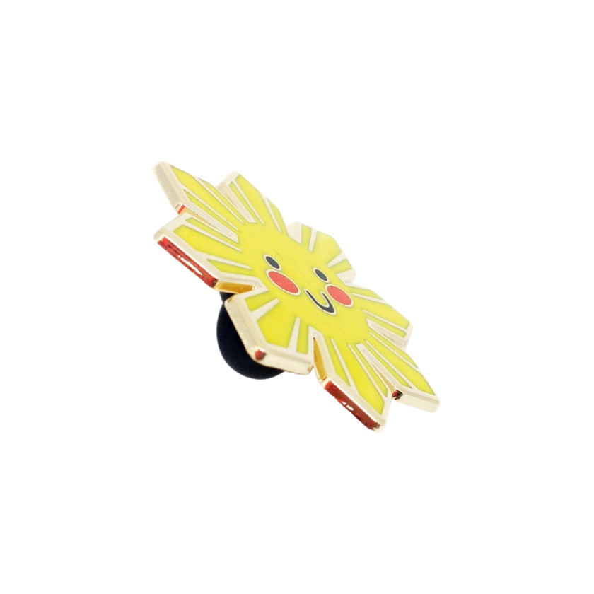 Pin with a cartoonish sun design of a character with a yellow face and red hair on a white background