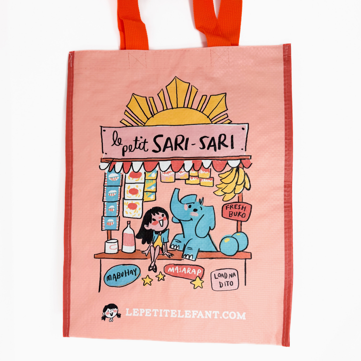 Tote bag with cartoon illustration of a market stand and text 'Le petit Sari-Sari' on a pink background.