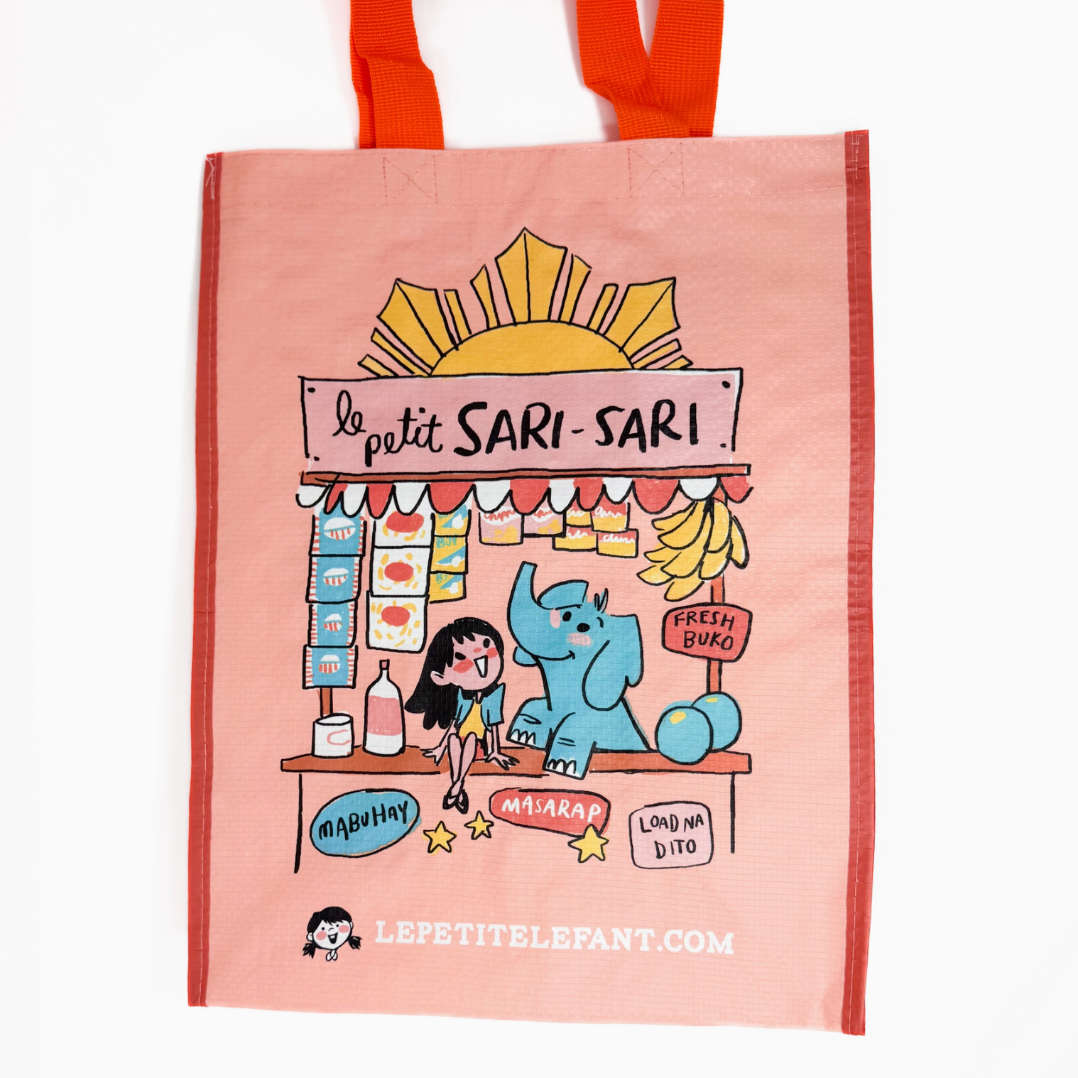Tote bag with cartoon illustration of a market stand and text 'Le petit Sari-Sari' on a pink background.