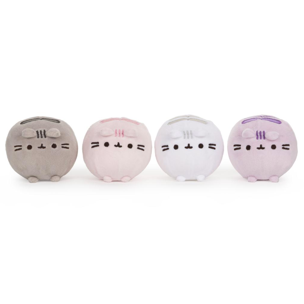 Four round Pusheen cat coin purse plushies in gray, pink, white, and light purple, lined up side-by-side on a white background.