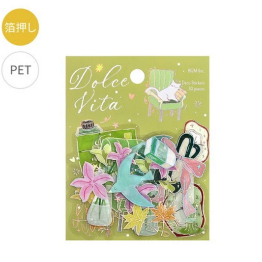 A package of Dolce Vita PET pet sticker toppers on a light gray background. The packaging is light green and features illustrations of a cat in a chair, a bottle, and pink lilies, with the brand name 'Dolce Vita' prominently displayed.