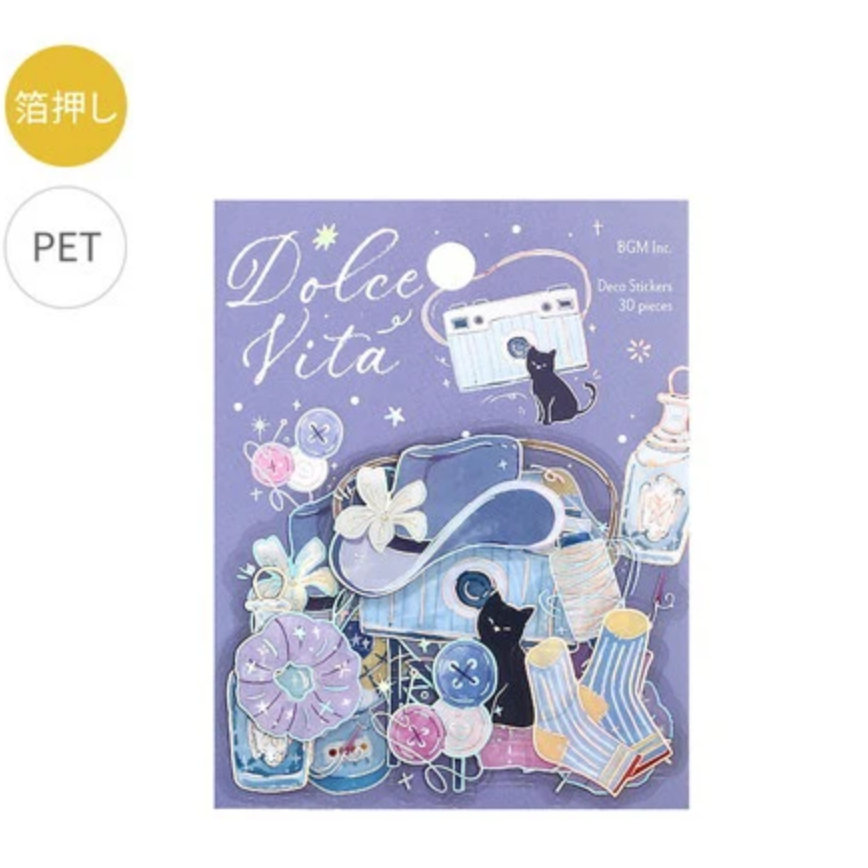 Dolce Vita PET sticker pack featuring cute illustrations of a black cat, retro cassette tape, flowers, and pastel-colored objects on a purple background.