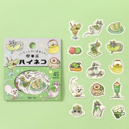 A package of 45 cute cat-themed stickers on a light green background, with several individual stickers displayed to the right. The stickers feature illustrated cats, drinks, desserts, and teapots in pastel colors.