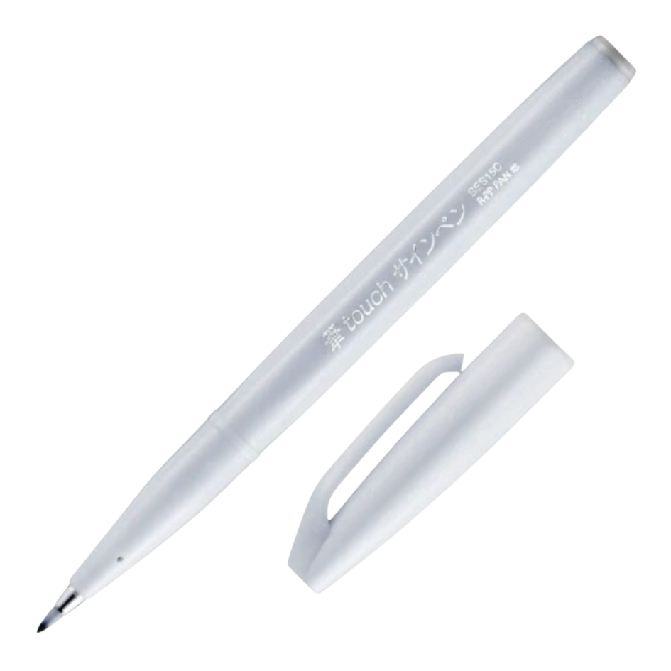 A white fine-tip marker pen with its cap removed, shown diagonally on a plain white background. The barrel has Japanese text printed on it.