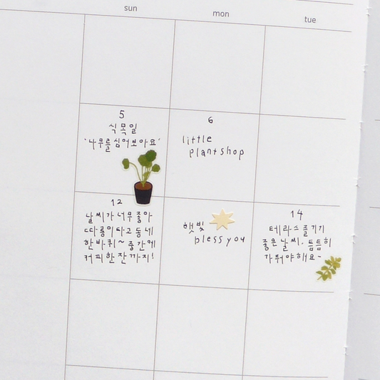 A white daily planner or calendar page with columns for sun through wed and handwritten notes in French and Korean, on white calendar background.