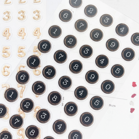 Stickers featuring black circular numbers with white numerals, shown alongside beige Arabic numeral stickers on a white background.