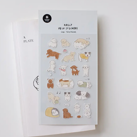 A sheet of cute dog-themed daily sticker decals displayed on a white card, with a second white card partially visible behind it on a light gray background.