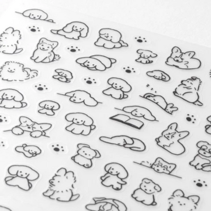 A sheet of clear nail stickers featuring cute black line-art illustrations of dogs, cats, rabbits, and paw prints on a white background.