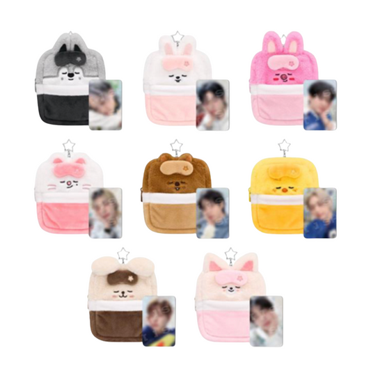 Nine small plush character pouches arranged in a 3x3 grid on a white background, each with a photo ID slot on the front. The backpacks come in different colors and animal designs including gray/black, pink/white, brown/white, yellow, and cream/brown.