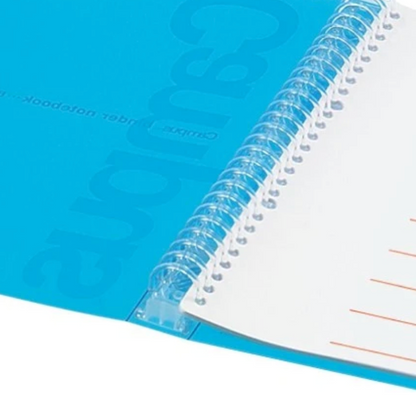 A close-up of a spiral-bound notebook with a translucent blue cover and white lined pages, bound by a clear plastic spiral.