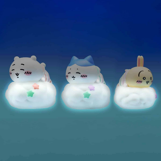Three cute cartoon animal night lights shaped like a bear, a cat wearing a blue hat, and a bunny, each resting on a glowing cloud. The products are shown against a dark blue gradient background.