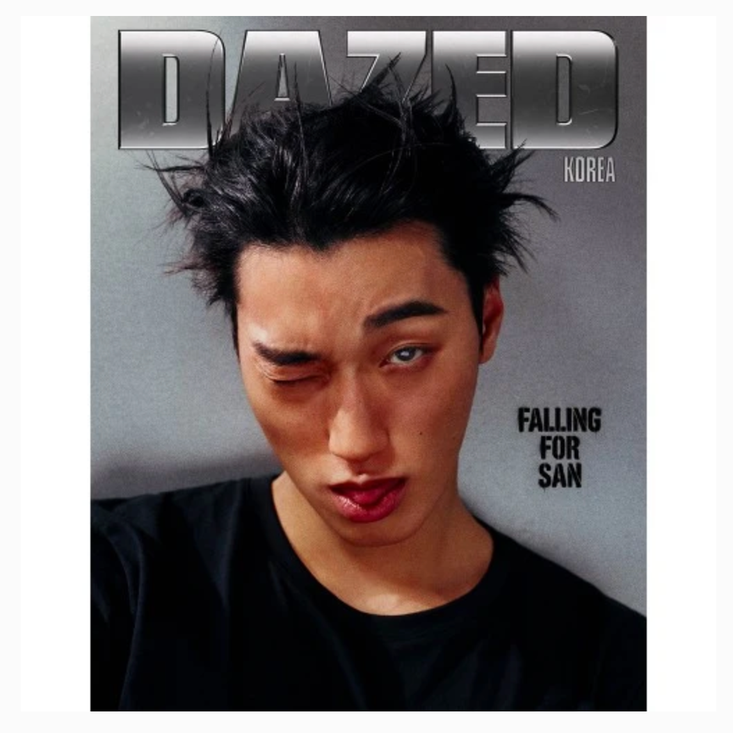A magazine cover featuring a close-up portrait of a man with messy dark hair, wearing a black shirt against a gray background. The masthead reads 'DAZED' with 'KOREA' below it, and the cover text includes 'FALLING FOR SAN'.