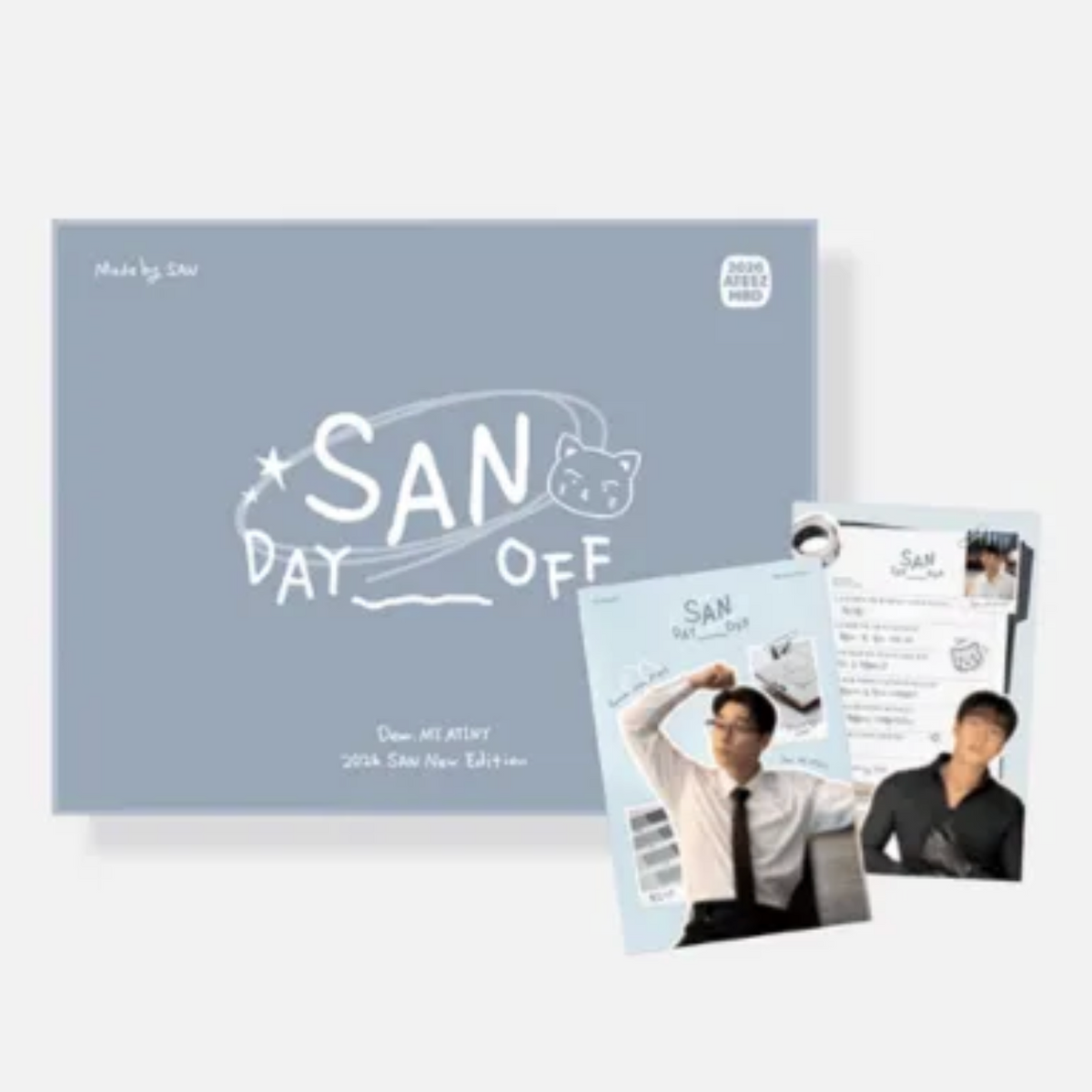 A boxed collectible item labeled 'SAN DAY OFF' with printed photos and cards arranged in front on a light gray background. The box is pale blue-gray with white handwritten-style text and graphics, and the cards show a man in a white shirt and black tie, plus other printed inserts.