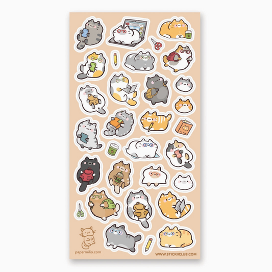 A sheet of cute cartoon cat stickers on a peach background, featuring multiple small die-cut cat illustrations in gray, white, orange, black, and yellow with tiny accessories like laptops, mugs, and books.
