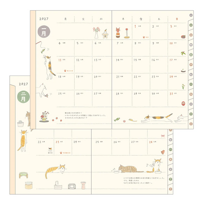 A Japanese cat-themed monthly calendar page set with illustrations of cats, small household items, and cute decorative details on a cream background.