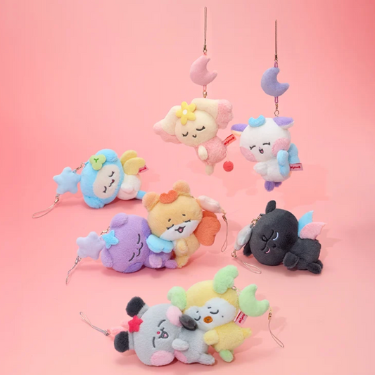 A set of seven pastel-colored plush keychain charms with crescent moon and star accessories, displayed against a solid pink background.