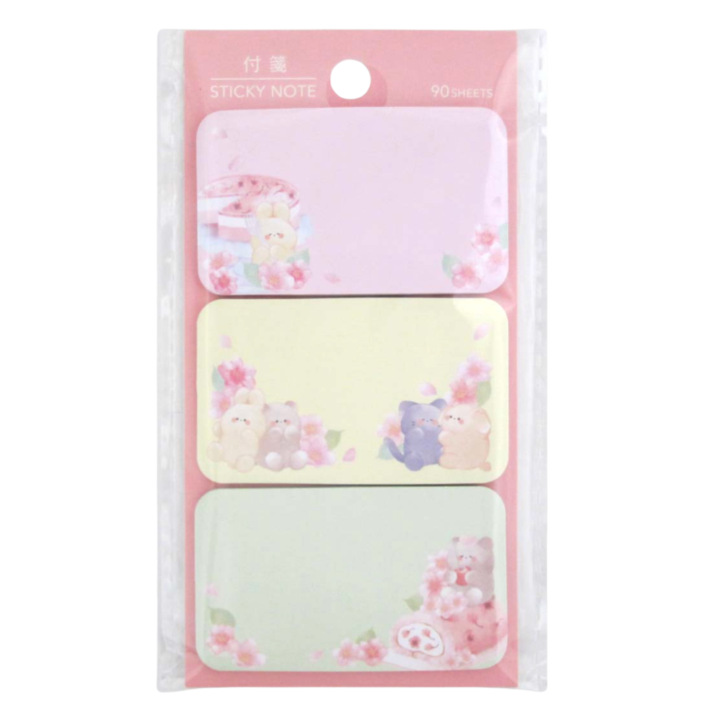 A package of three pastel sticky notes with cute cartoon bear illustrations and pink floral details, shown in a clear plastic sleeve on a white background.