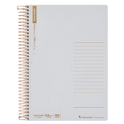 A light gray spiral-bound notebook with a white wire coil and gold-brown printed text and lines, shown on a plain white background. The brand Maruman is visible in the bottom right corner.