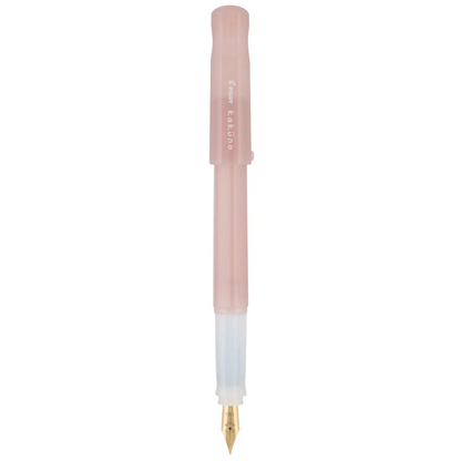 A translucent pink fountain pen with a gold nib and a white cap, shown vertically against a plain white background.