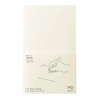 An off-white MD Notebook A6 Slim Book with a white elastic closure band, featuring minimalist black line art of a hand writing and Japanese text on the lower half.