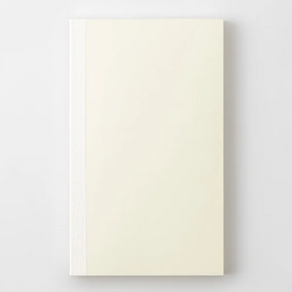 A cream-colored hardcover notebook with a textured spine, shown flat against a light gray background.