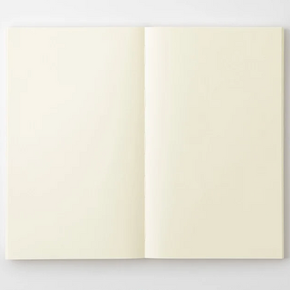 An open notebook with blank, warm cream-colored pages, displayed flat against a clean white background.