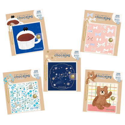 Five packaged Chocolog notepad sets arranged on a white background, each with a different illustrated cover design including a chocolate cup, candy motifs, stars, and a teddy bear.
