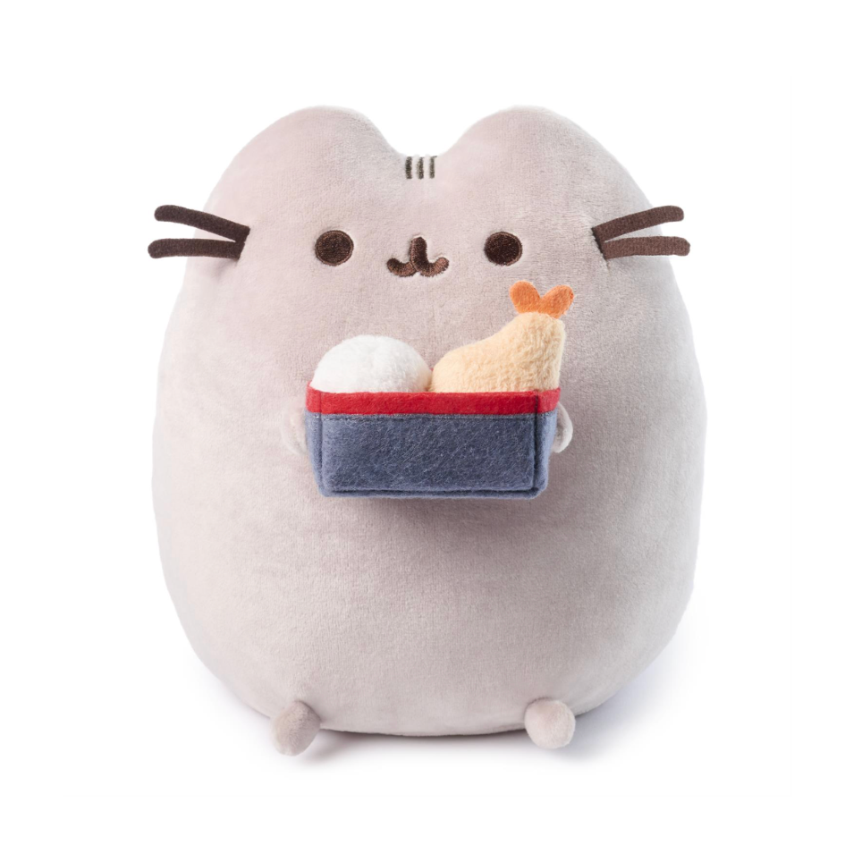 Plush toy resembling a cat holding a bento box on a white background