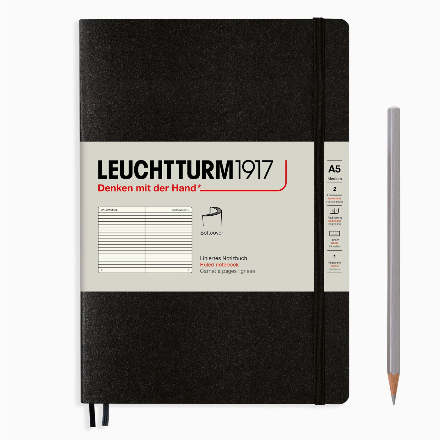 Black notebook with visible branding and a pencil on a white background