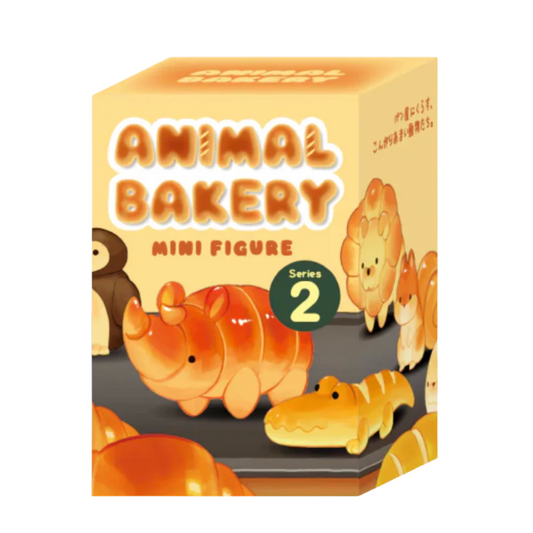 Box of Animal Bakery mini figures with rhino and crocodile designs on a beige background